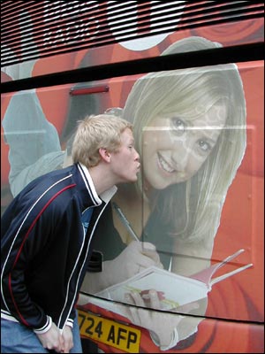 Boy kissing wrapped bus