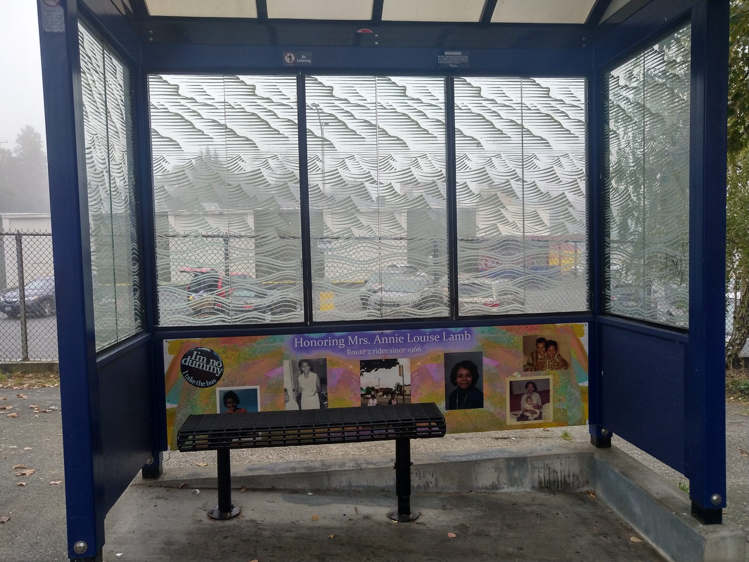 A bus shelter with a mural honoring Annie Lamb