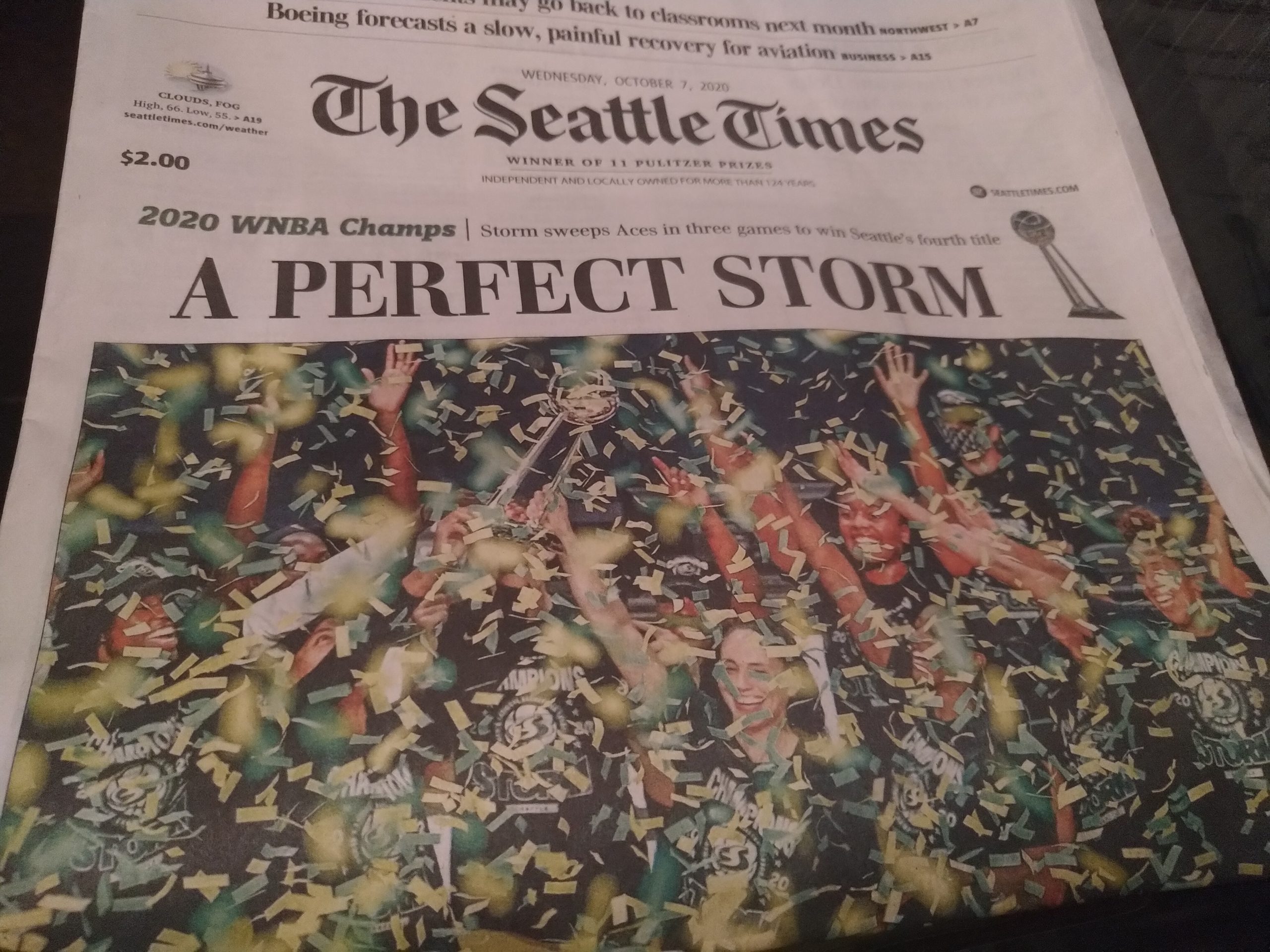 Image description: A newspaper front page with the headline, "A perfect Storm." Below the headline is a photo of the Storm players, celebrating as green and yellow confetti falls around them.